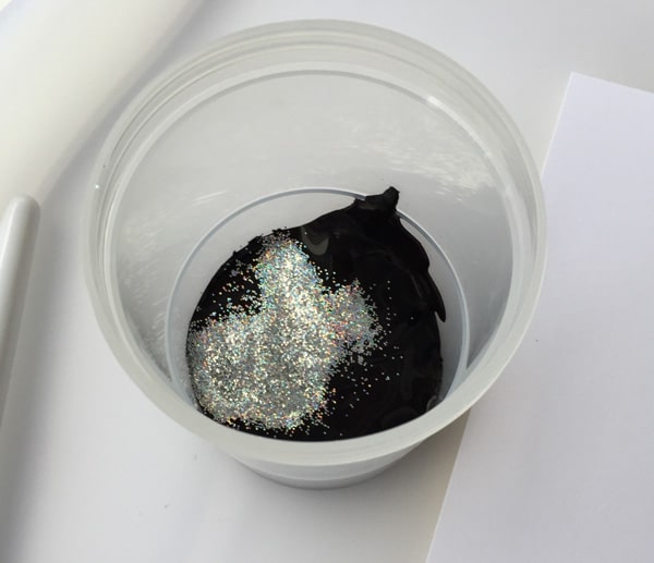 Add glitter to paint to make it shiny and to create stars in the sky