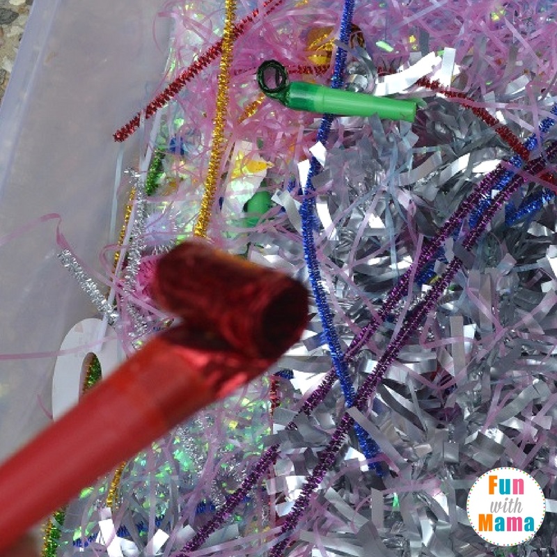 New Year's Eve sensory bin playing 2