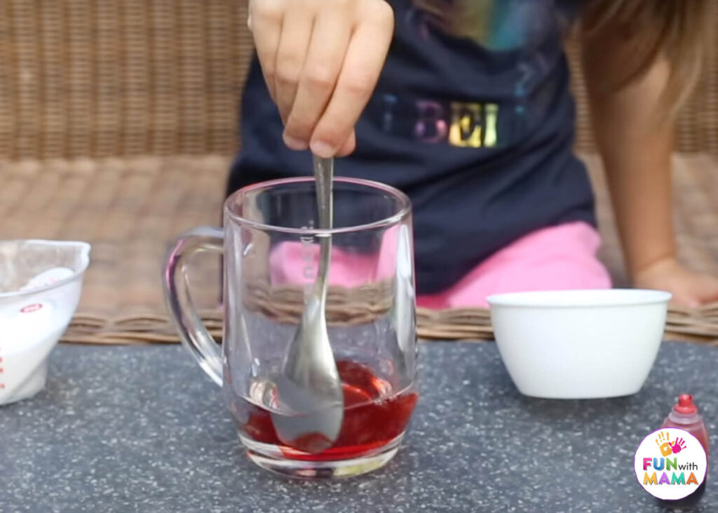 mixing red food coloring with vinegar