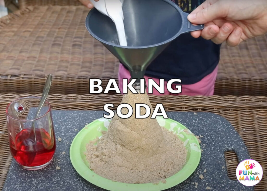 adding baking soda to the homemade volcano