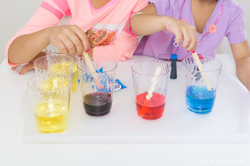 clear cups with water and food coloring inside