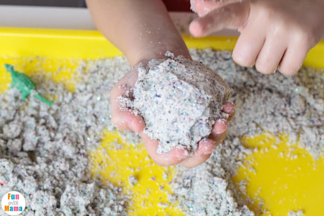 picking up and playing with the moon dough 