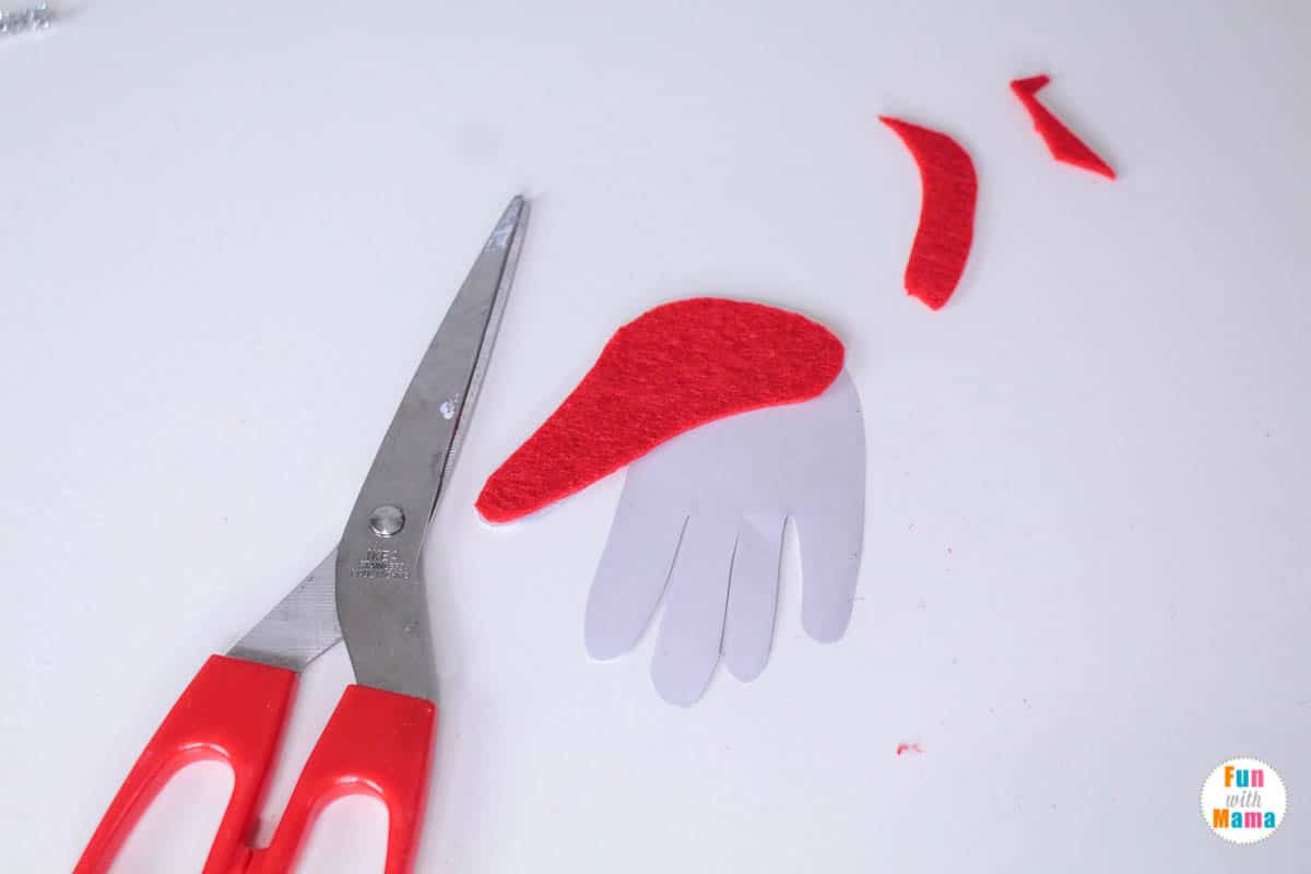 cutting out the pieces for the handprint santa craft 