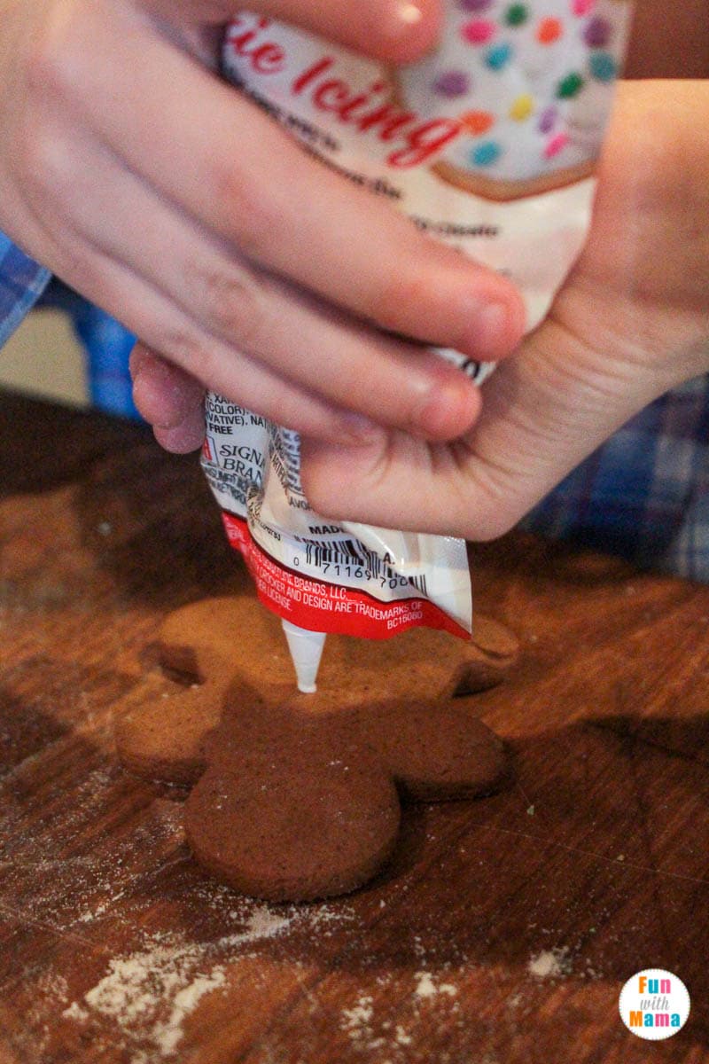 putting the cookie icing on the gingerbread cookies 