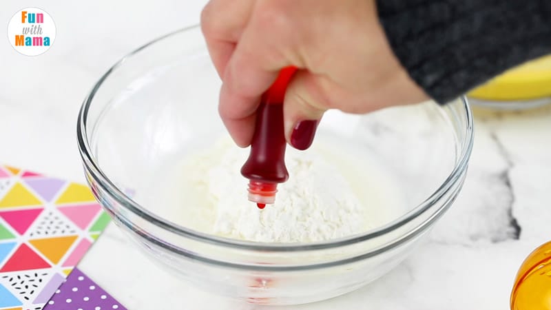 adding in food coloring for making oobleck 