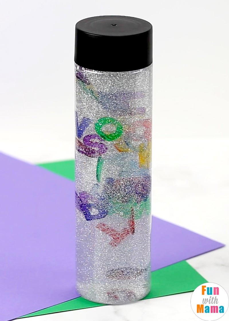 silver glitter in a bottle with alphabet letters floating inside 