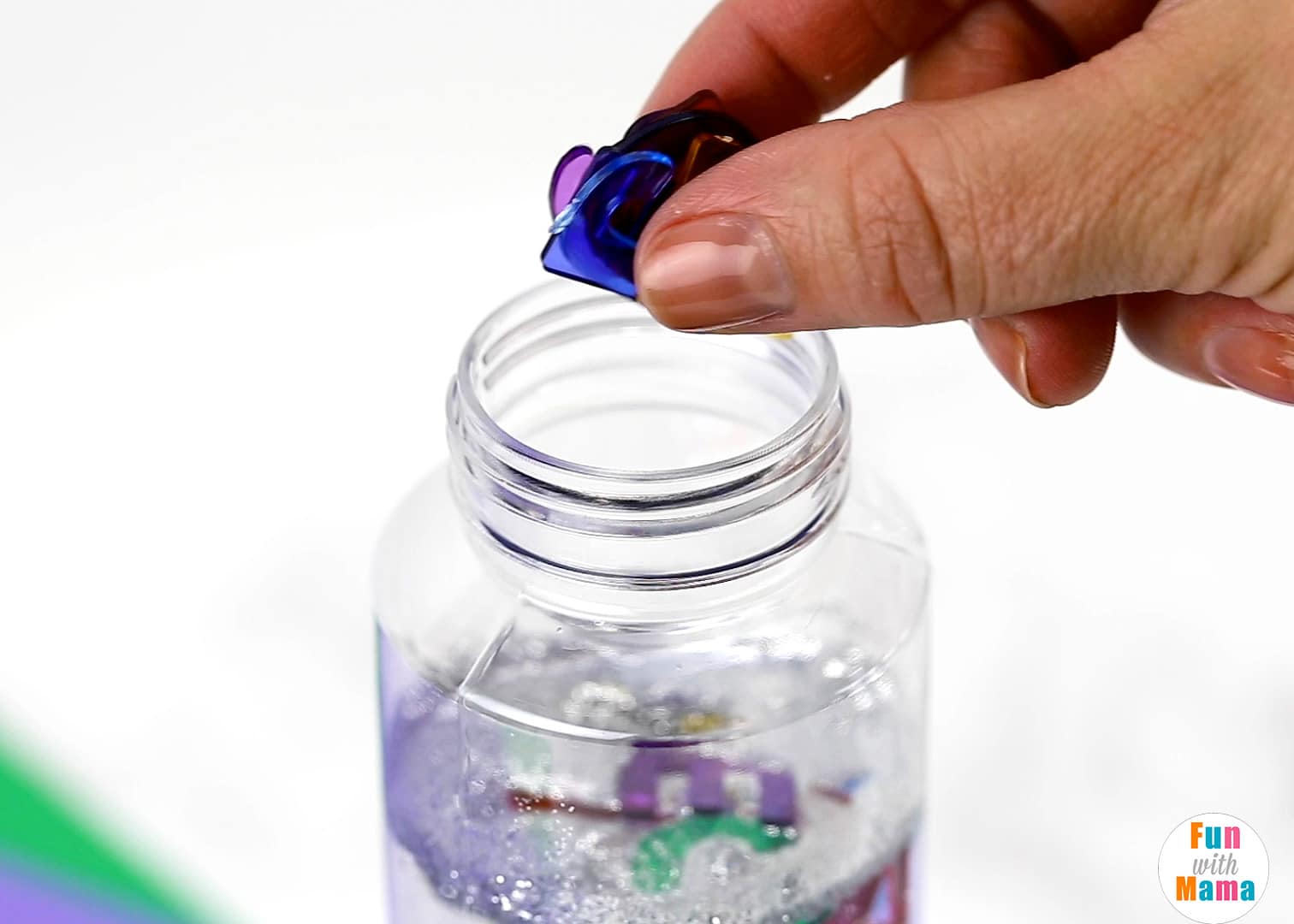 adding items to a sensory bottle 