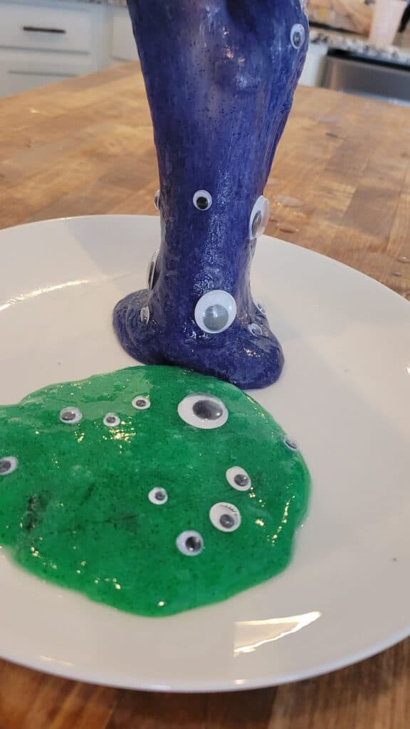 green and blue googley eye slime on a plate 