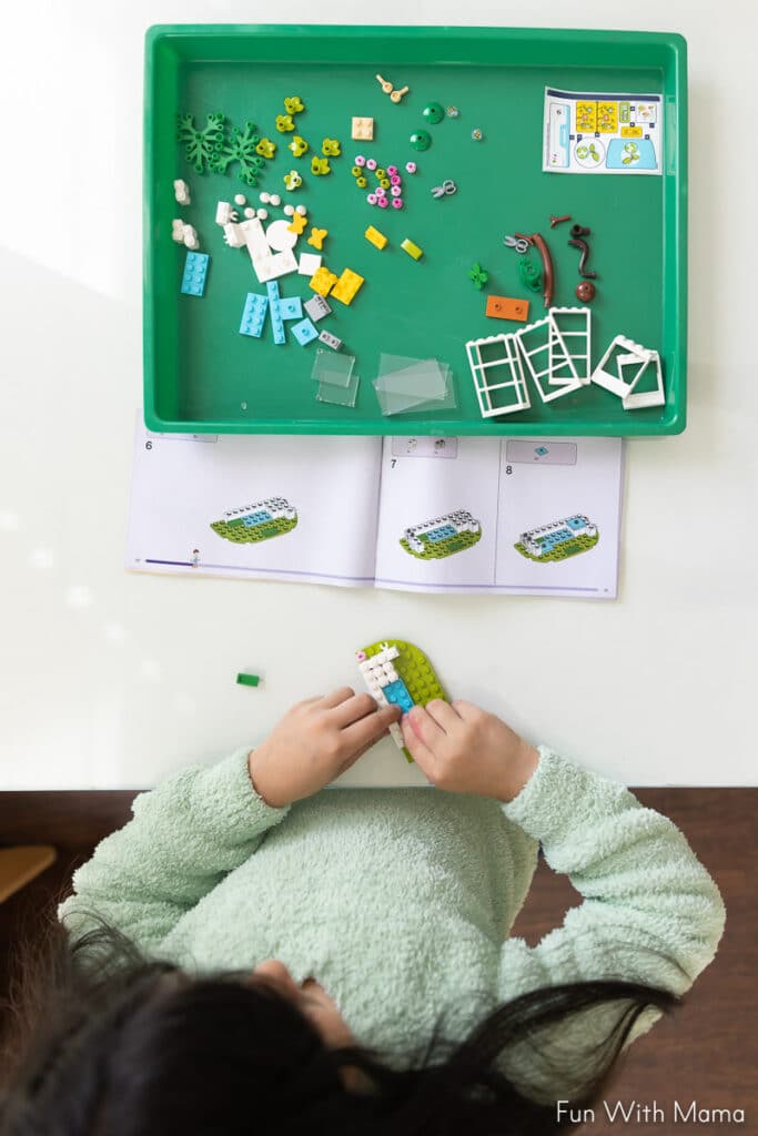 child following directions and building with legos