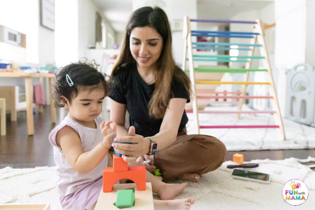 mom and daughter playing with wooden blocks