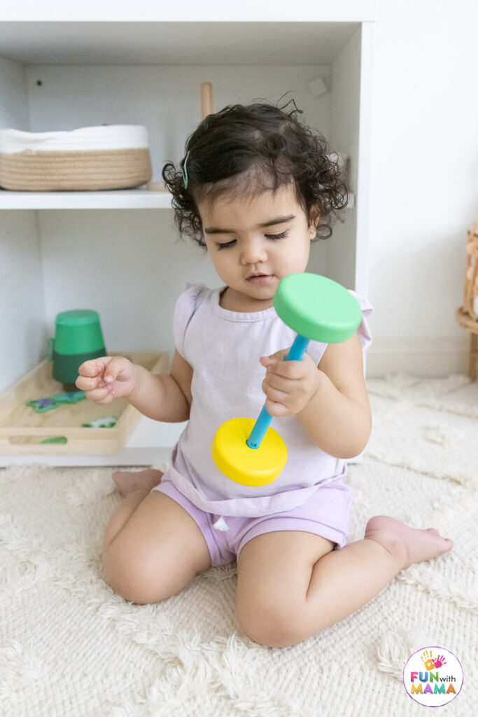 child playing with wooden blocks and toys