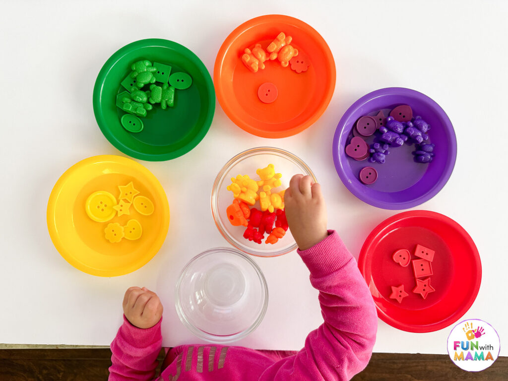 sorting colors of counting bears and colored buttons into bowls