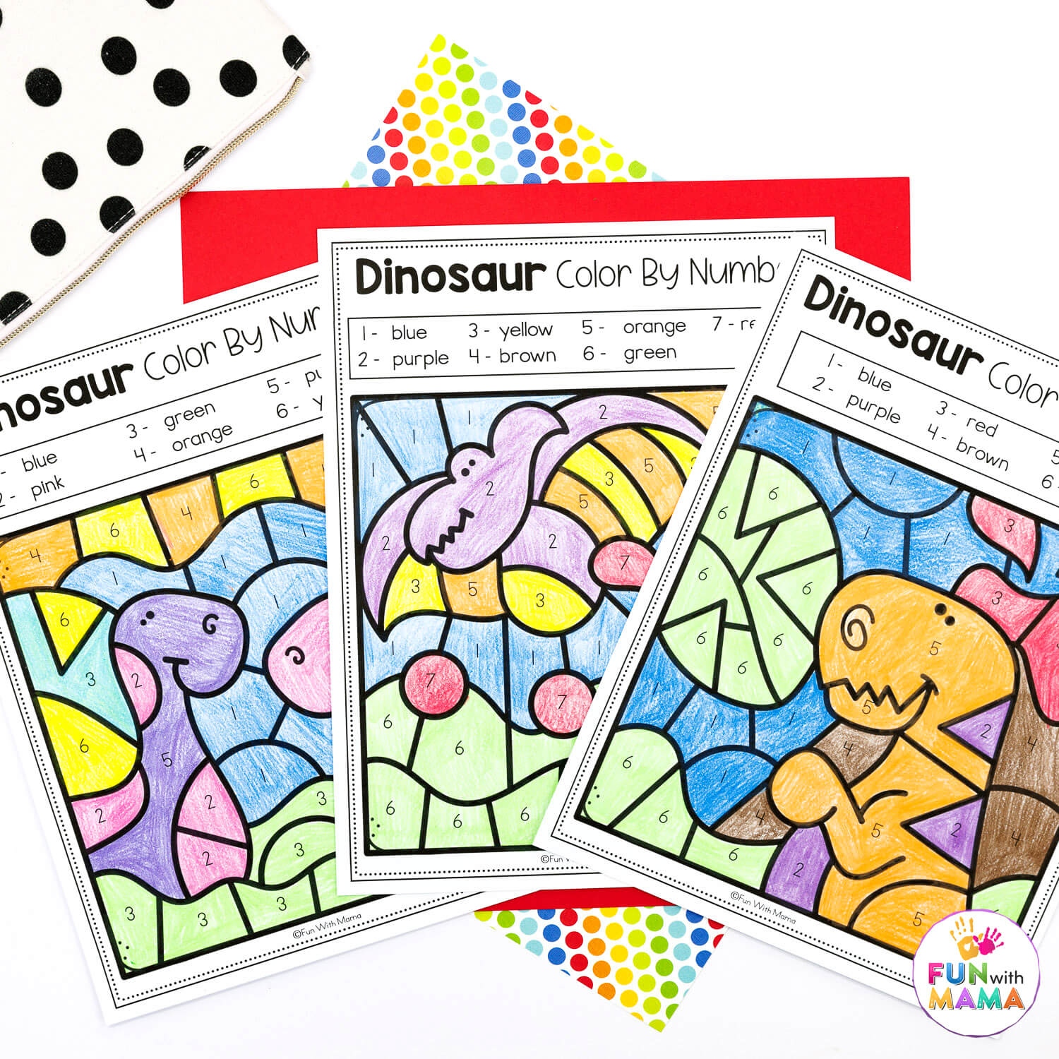 color by number dinosaur flat lay of 3 worksheets colored in with 6 different colors