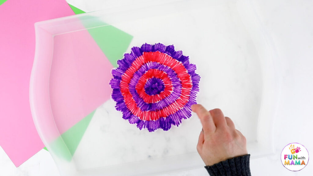 spraying colored coffee filter with water